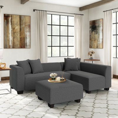 Canapé modulaire modulaire en L avec repose-pieds et coussins décoratifs gris anthracite avec pieds en plastique noir