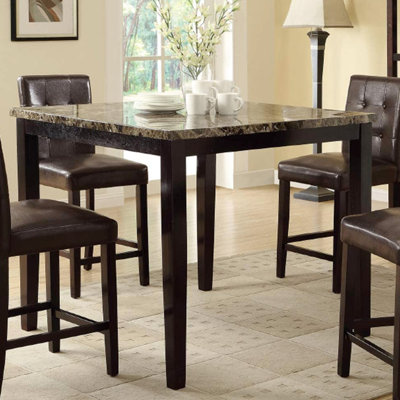 Table de salle à manger moderne moderne avec plateau en faux marbre foncé et placage de bouleau