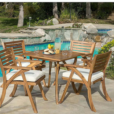 Ensemble repas d'extérieur en bois avec coussins 5 pièces Hermosa