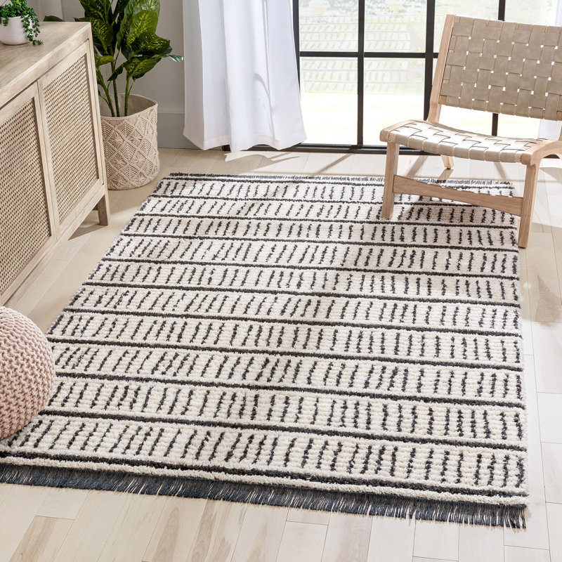 Ivory and Black Geometric Synthetic 4' x 6' Area Rug