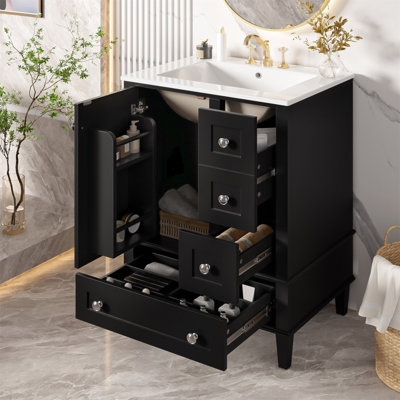 Meuble-lavabo noir de 24 po avec lavabo intégré en céramique, tablette à double couche, tiroirs à fermeture en douceur et porte d'armoire à fermeture en douceur.