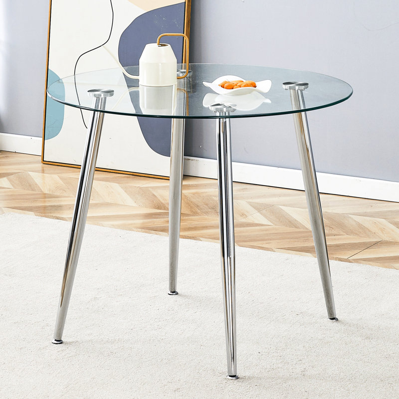 Table de salle à manger circulaire avec plateau en verre et pieds en métal