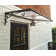 Palram - Canopia Venus 4' 5" W x 2' 11" D Slope Door Awning in Dark Gray