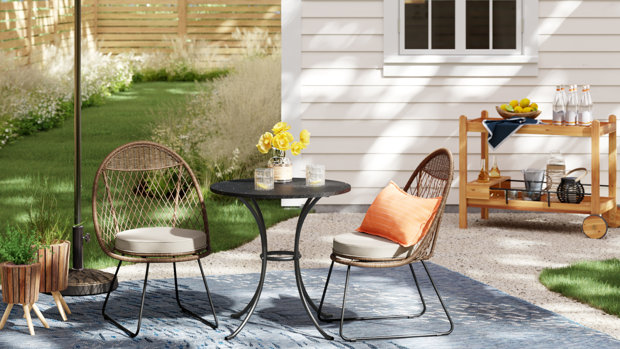 Patio scene with chairs, table, and bar cart.