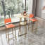 Ensemble de table et chaises de bar, ensemble de trois pièces, structure dorée, coussins et dossiers de siège en éponge, table de bar avec rangement (coussin doré / beige / orange)