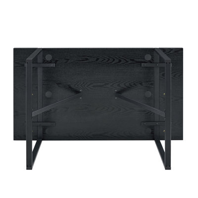 A 55-Inch minimalist retro rectangular dining table with a black textured top with Inset Rectangular Black Metal legs.Minimalist MDF Tabletop.Meeting