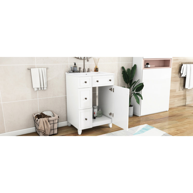 Meuble-lavabo de 24 pouces avec lavabo en céramique. Gain de place. 2 tiroirs, 1 porte. Et bois. Blanc. Facile à entretenir - il y a beaucoup d'espace de rangement. Assemblage