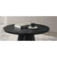 Table basse ronde de couleur noire avec base à piédestal conique, style moderne et contemporain pour le salon