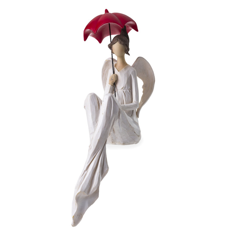 Statue d’ange assis avec un parasol rouge