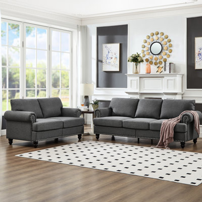 Canapé en tissu 5 places moderne et classique pour le salon, revêtement en gris, rond avec clous argentés, structure en bois massif, coussins amovibles, rangement sous les sièges, clous, structure