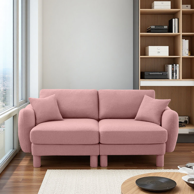 Canapé 2 places avec accoudoirs en forme de coquillage et pieds cylindriques enveloppés de tissu d'ameublement Boucle, Rose