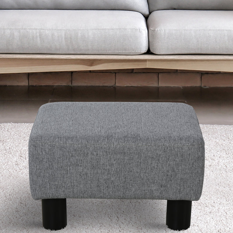 Tabouret gris avec housse en lin et pieds robustes en plastique pour le repos de style salon, petit