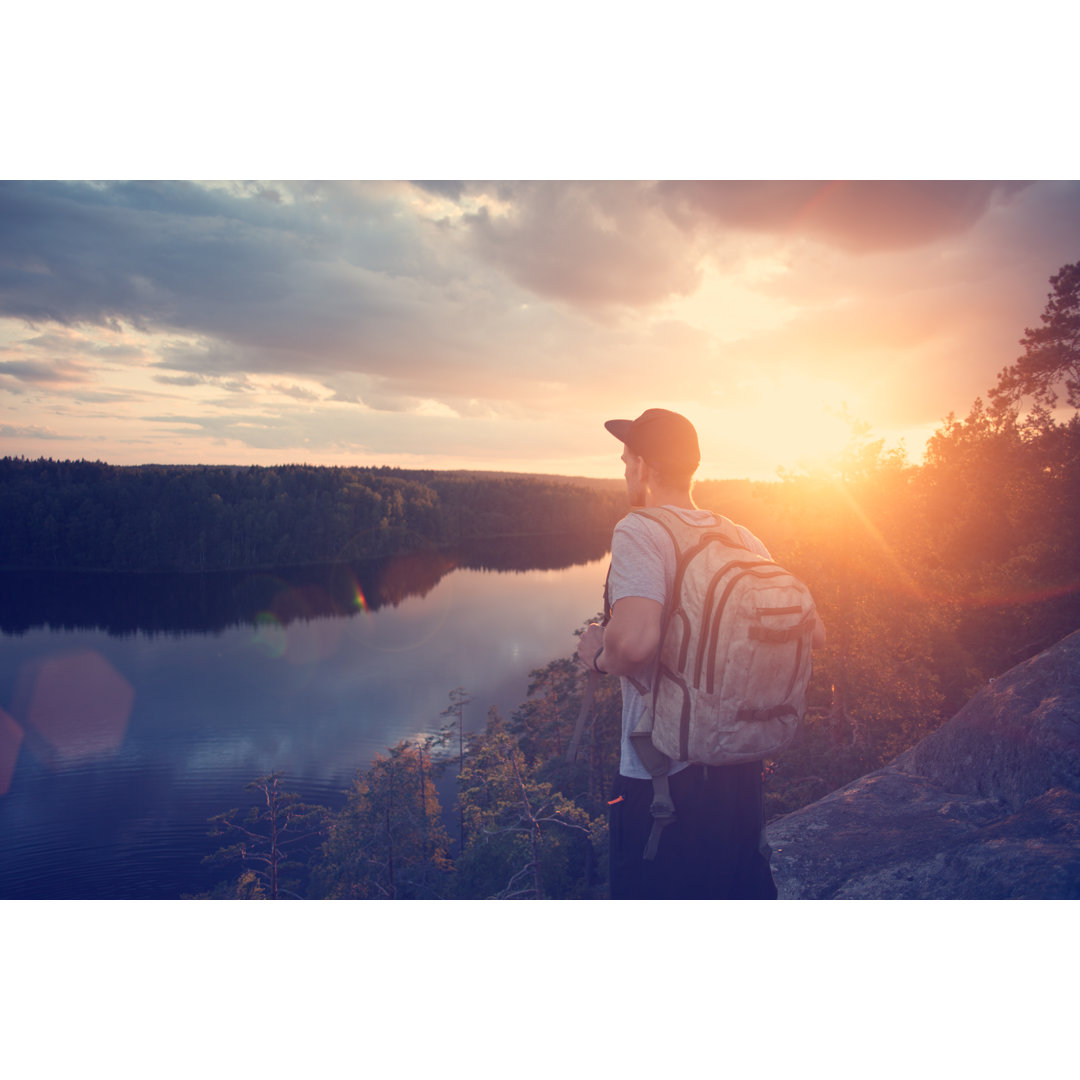 Leinwandbild Man with Backpack Looking at Sunset von Littlehenrabi