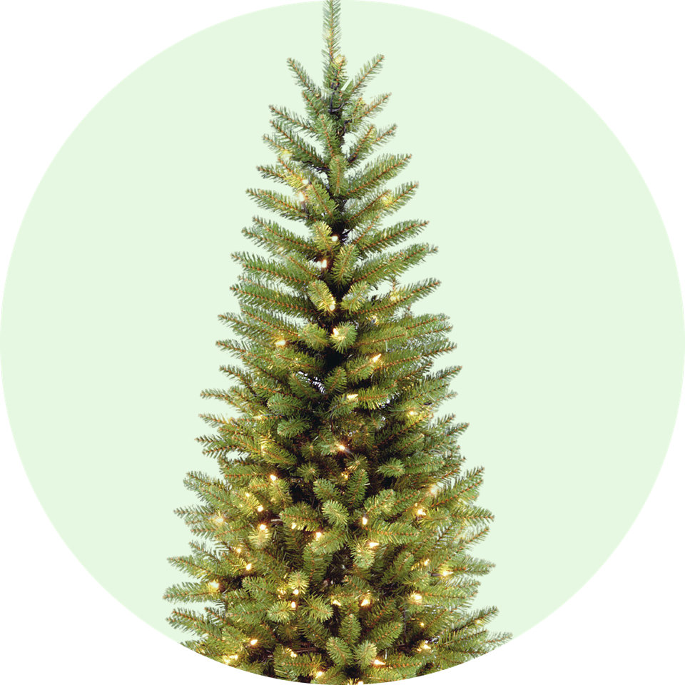 A narrow Christmas tree with warm lights.