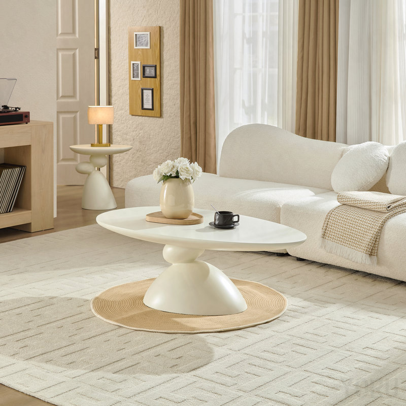 Table basse elliptique moderne en forme de pierre moderne, base sculpturale pour petits espaces, finition blanc laiteux