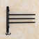 Wall-mounted oscillating towel rack for bathroom use with practical hooks
