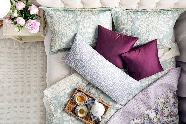 bed with silk purple pillowcases
