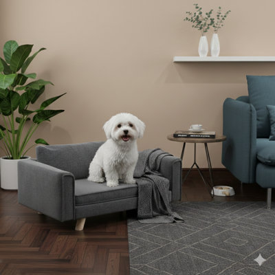 Lit surélevé de style canapé pour petits et moyens chiens, avec coussins de siège et de dossier amovibles, équipés de patins antidérapants sur la base, de couleur grise.