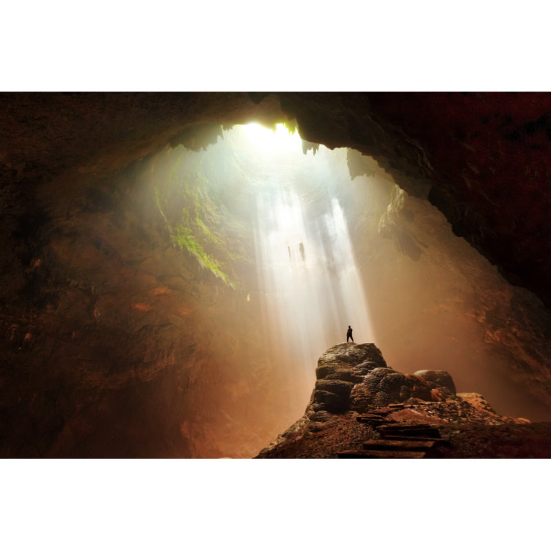 Man Standing On Rock Underground Cave Light Yogyakarta Indonesia by BudiNarendra - Wrapped Canvas Print