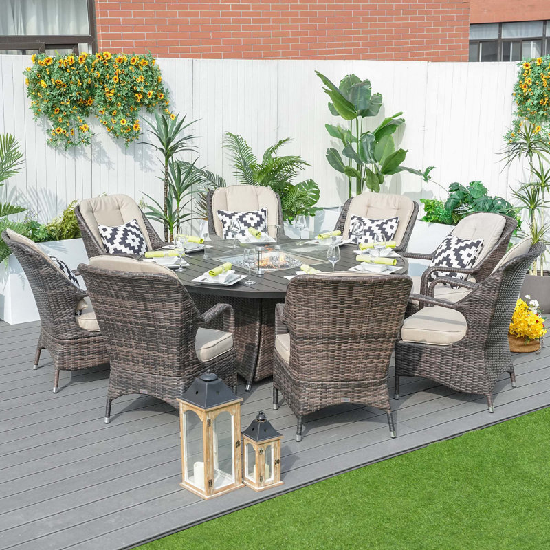Natascha 8 - Person Wicker Patio Dining Set with Round Table , Cushions Included, Brown