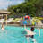 Outsunny Wicker Pool Float Storage Organizer, PE Rattan Outdoor Pool Float Holder with Rolling Wheels & Storage Rack