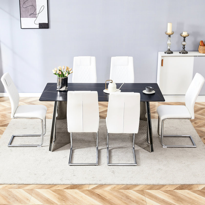 Table en marbre noir et 6 chaises en polyuréthane blanc avec structure stable pour une base familiale