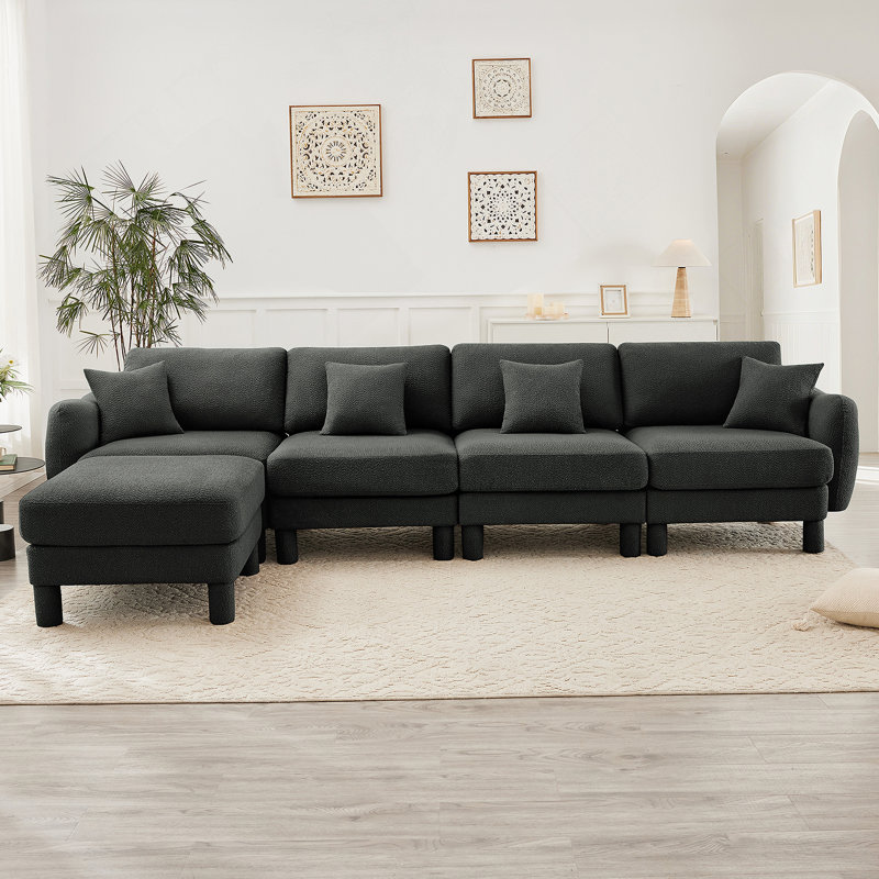 Canapé-lit modulaire convertible en forme de L à 4 places avec accoudoirs en forme de coquille distinctive, repose-pieds amovible et pieds cylindriques pour des espaces de vie polyvalents