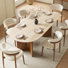 Ensemble de table de salle à manger Korolevu de style Mid-Century moderne pour 6 personnes pour 6 personnes, comprenant un plateau de table en travertin beige avec une double base en bois, une table de salle à manger ovale murale avec 6 chaises de salle à manger en tissu et des pieds en bois
