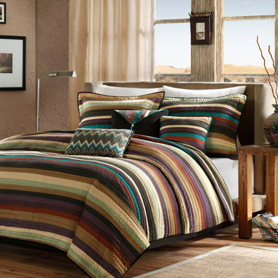 King/ King Reversible Quilt With Throw Pillows. Microfiber For Effortless Maintenance. Enrapturing Stripe Pattern In Purple, Teal, And Earth Tones. 2 Shams 3 Decorative Machine Washable Bedding