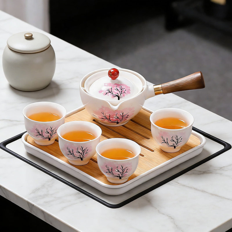 Service à thé 360 ° tournant en céramique avec sac en cuir gongfu, théière et tasses Sakura sensibles à la température, complet avec plateau à thé pour faciliter l'infusion et le voyage