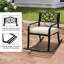 Chaise berçante en fer noir avec dossier floral et coussin blanc cassé