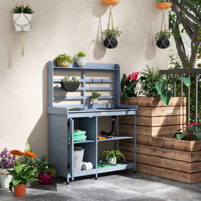 Table de rempotage en bois avec rangement, surface de travail et tablettes grises pour plantes, outils dans la cour, patio, pieds de glissade pour évier de banc d'extérieur, jardin propreté du bois