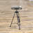 Simen Metal Film Reel Side End Black Accent Table with Tripod Legs and Glass Top