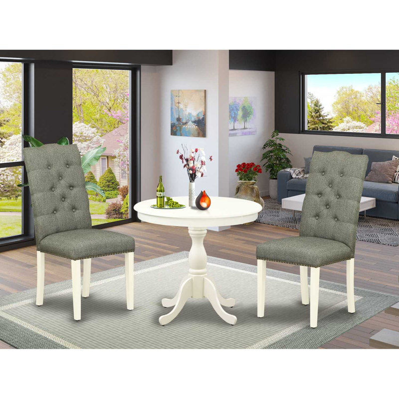 L'ensemble de salle à manger 3 pièces comprend 1 table à piédestal ronde et 2 chaises de salle à manger en tissu de lin fumé avec dossier capitonné et têtes de clous - fini lin blanc