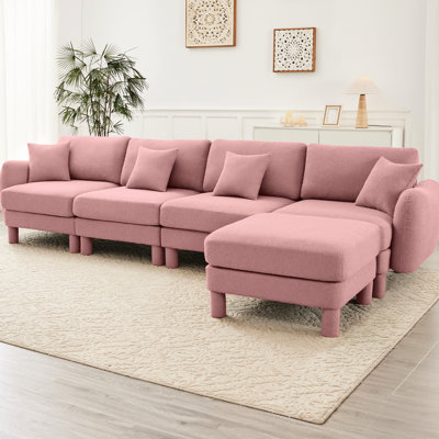 Canapé modulaire convertible en L à 4 places en tissu bouclé rose avec pieds en forme de coquillage, amovibles et cylindriques. Confort, durabilité, design moderne dans votre espace de vie. Repose-pieds