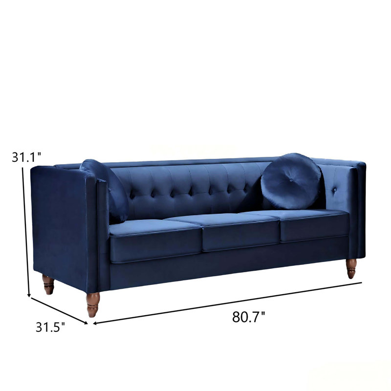 Canapé Chesterfield classique en velours froissé, accoudoirs carrés, structure en bois massif et capitonnage profond pour une décoration de salon élégante.
