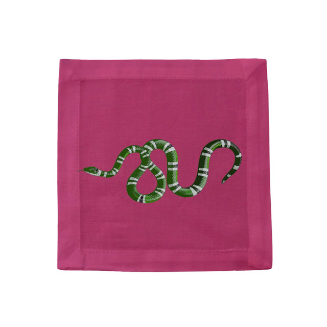 Square pink linen cocktail napkin featuring an embroidered green and white striped snake design.