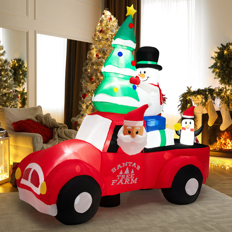 Grand père Noël conduisant une voiture gonflable