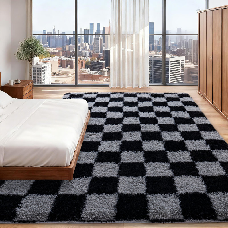 Black and gray checkered area rug with an ultra-soft, non-slip backing, suitable for living rooms, bedrooms, and nurseries.
