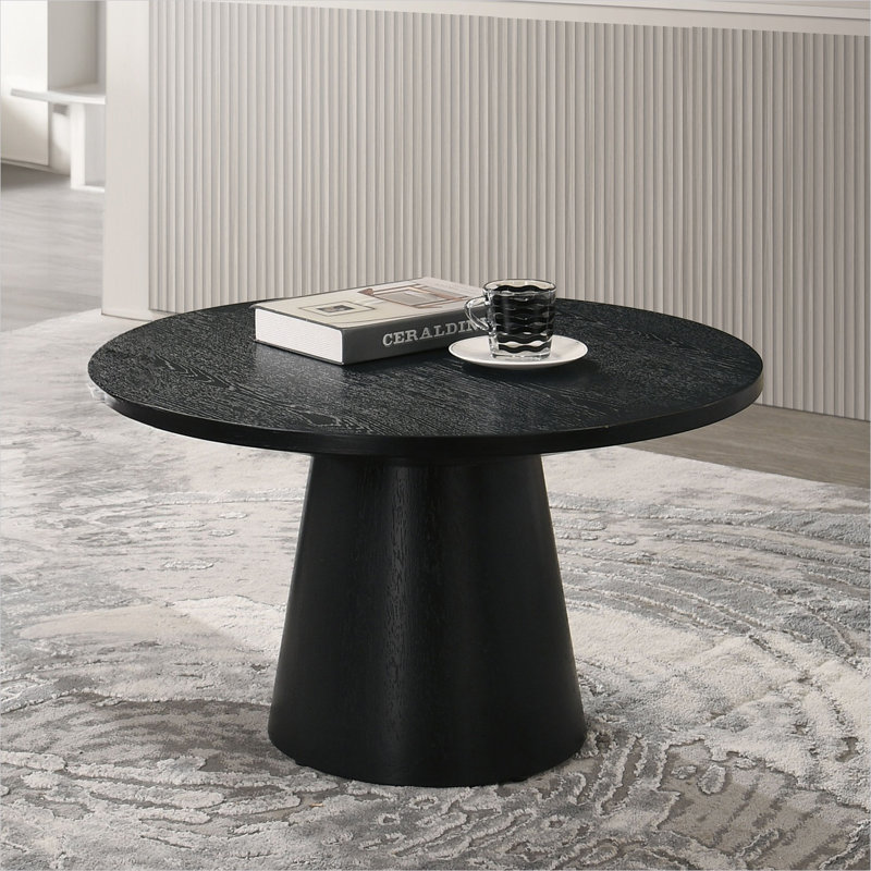 Table basse ronde de couleur noire avec base à piédestal conique, style moderne et contemporain pour le salon