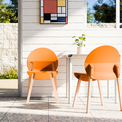 Ensemble de 4 chaises orange tropicales pour salle à manger et salon, pieds en chêne rouge, assise en polypropylène de qualité industrielle, imperméable et résistante aux rayures, pieds massifs fabriqués à la main, robustesse commerciale jusqu'à 150 kg, pour sol.
