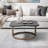 Beccaro Modern Black Stone Coffee Table with Antique Brass Iron Base and Sculpted Four-Leaf Design
