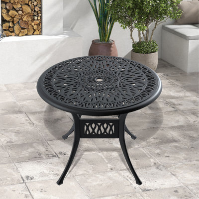 Table de salle à manger en fonte d'aluminium avec cadre noir et trou pour parasol