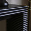Console moderne noire avec motif nervuré