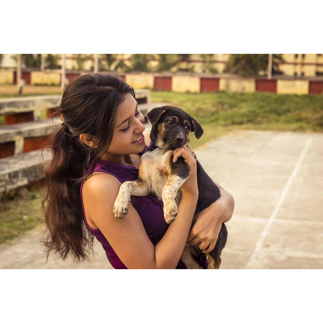 Young Teenager Woman With Little Puppy von Mantosh - Kunstdrucke auf Leinwand ohne Rahmen