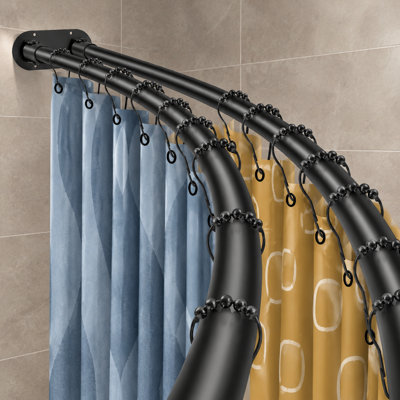 A black wall-mounted double curved shower curtain rod adjustable from 42 to 72 inches; the elegant double-pole design is intended for bathroom use and spans 42 to 72".