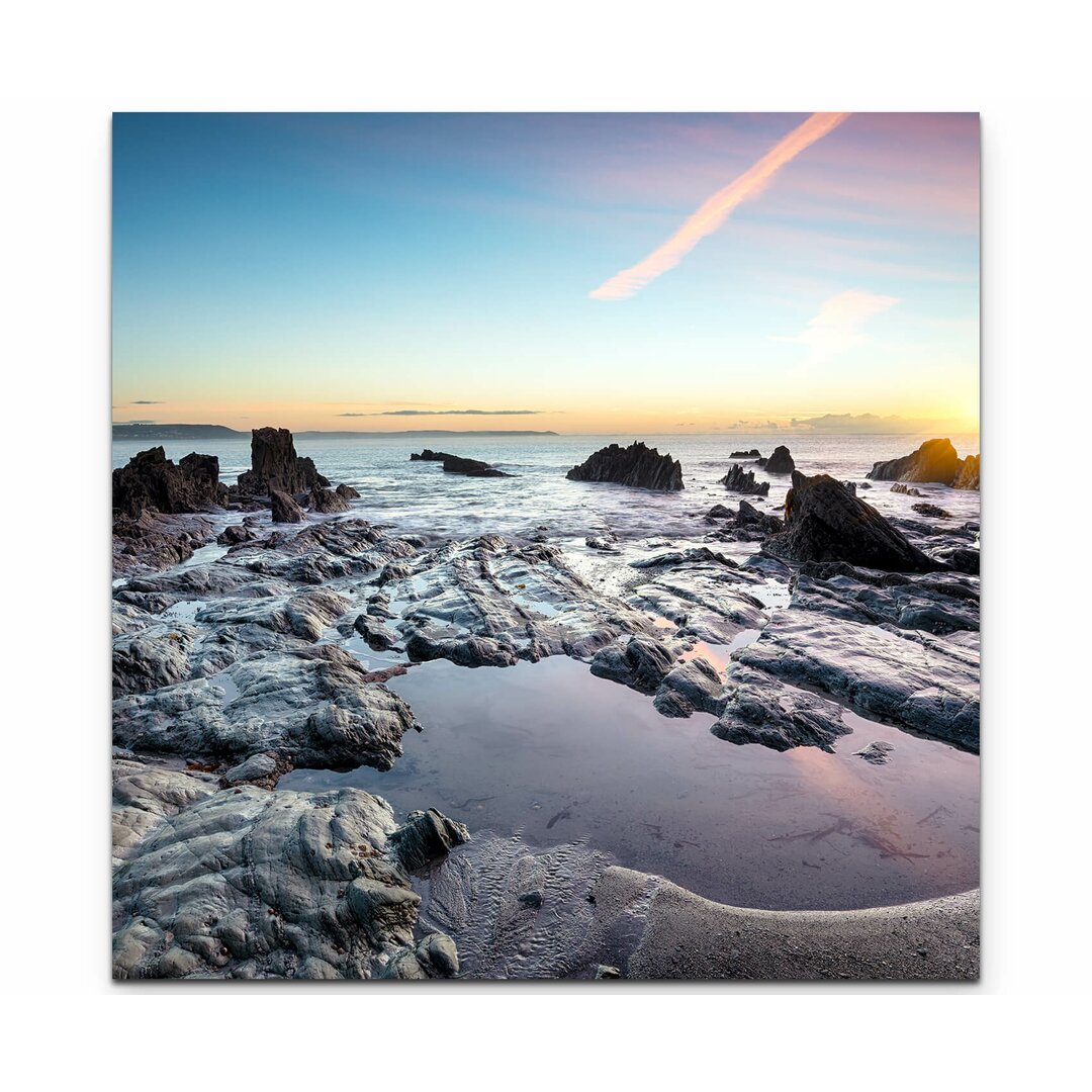 Leinwandbild Steinstrand in England Sonnenuntergang