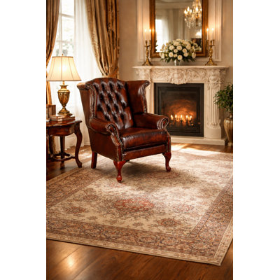 Fauteuil à oreilles en cuir touffeté à la main