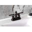 Robinet de salle de bain central à 4 poignées à 3 trous avec bonde escamotable Kingston Brass Kingston-95752650
