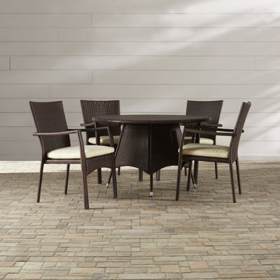 Arturas 4 - Person Wicker Patio Dining Set with Round Table , Cushions Included